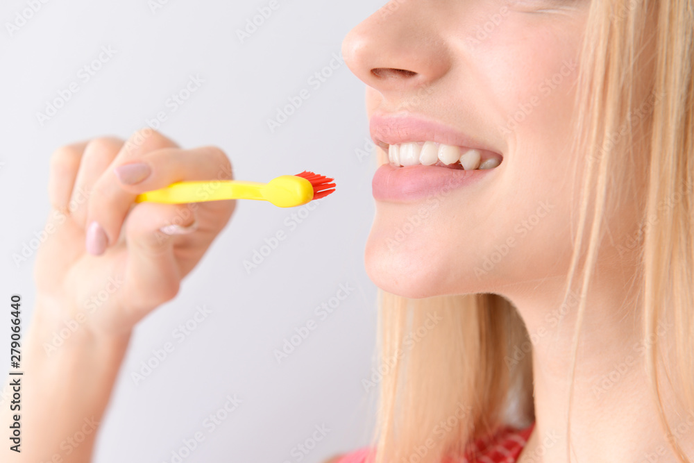 Woman with toothbrush on light background, closeup. Concept of dental hygiene Woman with toothbrush on light background, closeup. Concept of dental hygiene
