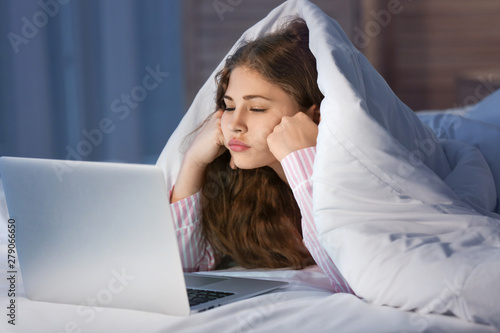 Teenage girl with laptop in...