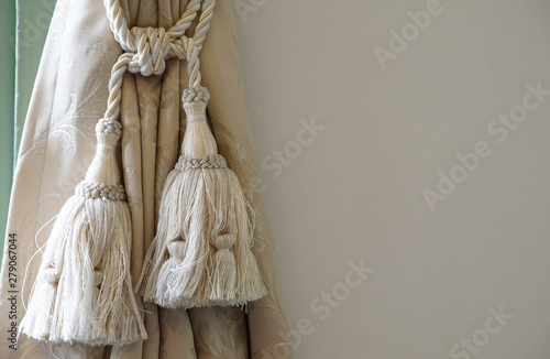 A wall and curtain tassel of the room photo
