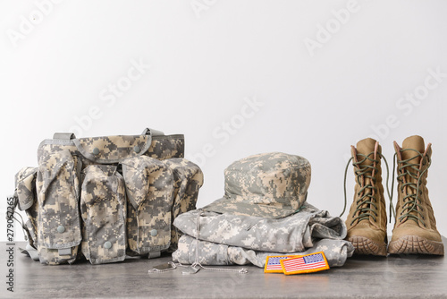 Military uniform on table against light background