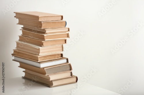 Stack of books on table against light background