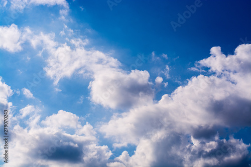 Bright blue sky with clean white airy fluffy clouds on a summer day