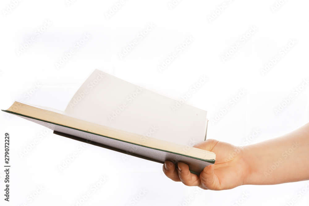 Woman's hand is holding book. Woman's hand is holding book.