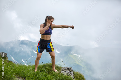 Kickboxing girl on the mountains