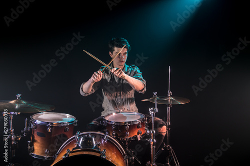 musician playing drums, black background and beautiful soft light