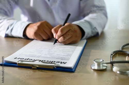 Doctor using computer medical record medical report or medical certificate database of patient's health care