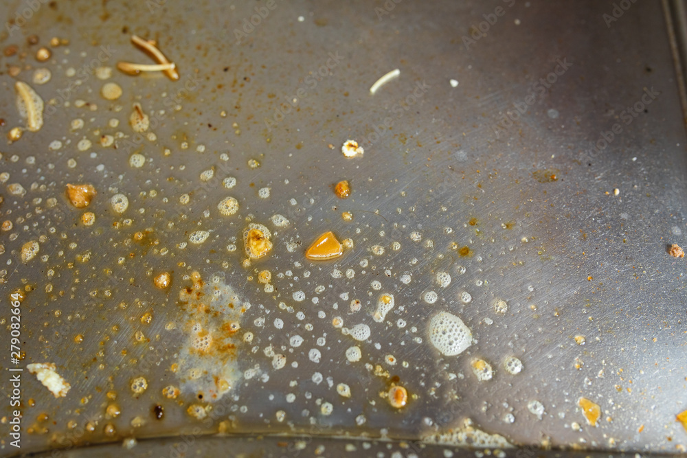 Close-up of dirty gas cooker covered with chemical washing liquid. Housework or household chores concept.
