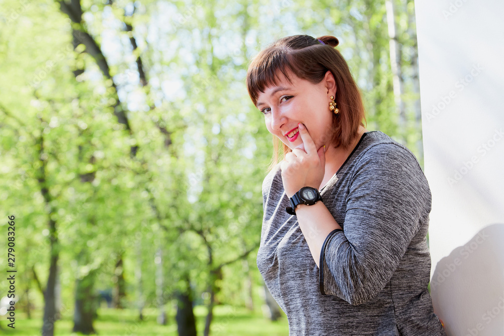 Portrait of beautiful cute girl in summer or spring park