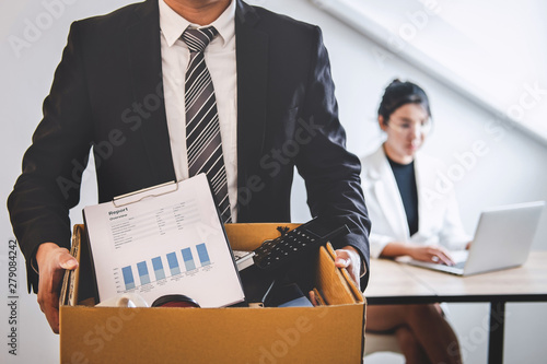 Businessman being sending resignation letter to company and carrying packing photo