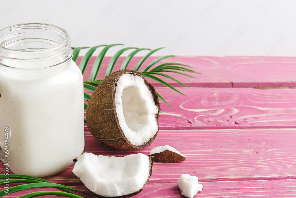 Coconut and a glass of coconut milk on a table. Healthy food concept Coconut and a glass of coconut milk on a table. Healthy food concept