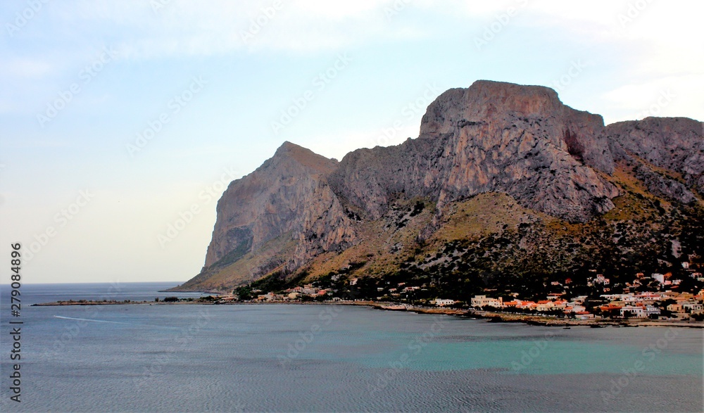 Fototapeta premium evocative image of maritime coast at sunset with fishing village in the background in Sicily, Italy