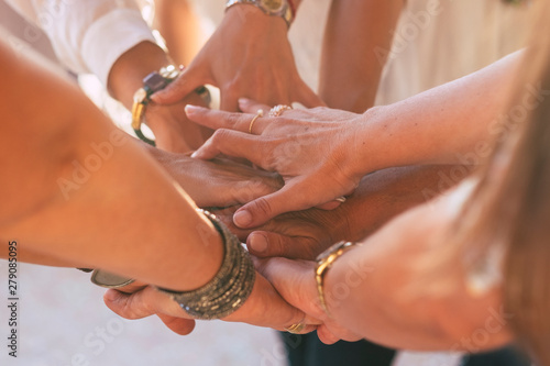 Close up with lot of women hands holding and touching each other for friendship concept - cooperation and help for caucasian females - friends forever and team at work - love lifestyle