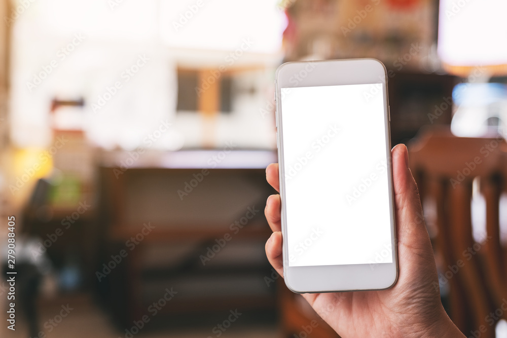 Mockup image of a woman's hand holding white mobile phone with blank desktop screen