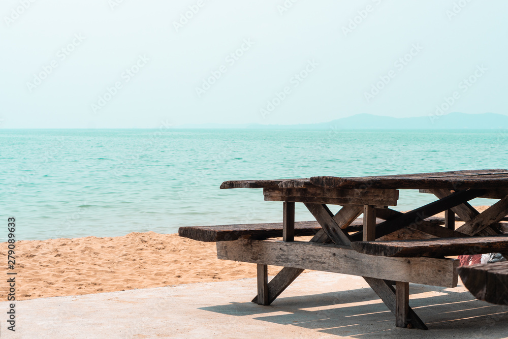 Old empty wooden park beach bench on the sea shore , rest relax summer background with copy space