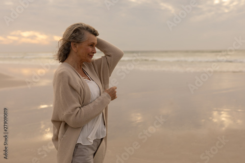 Senior woman standing on the beach