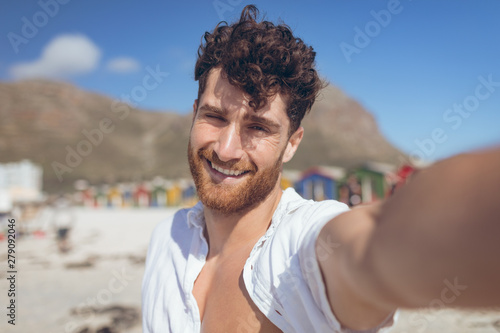 Happy man taking a selfie standing at beach  © WavebreakMediaMicro