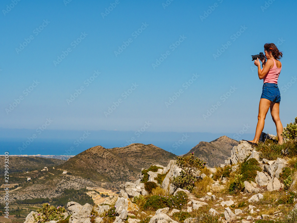 Woman take photo in mountains