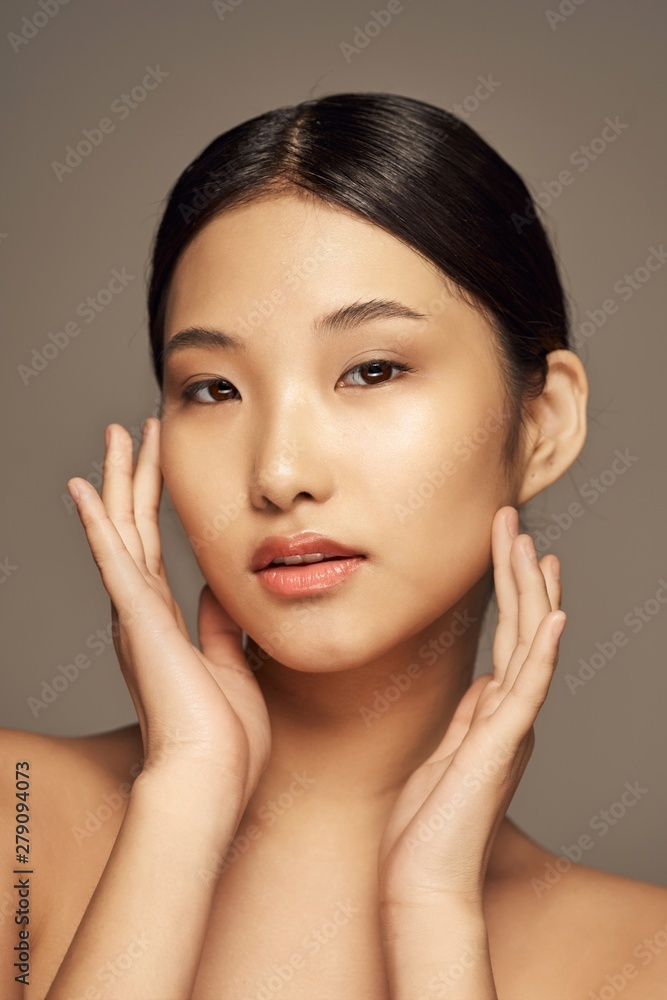 portrait of a beautiful woman with perfect skin looking at camera portrait of a beautiful woman with perfect skin looking at camera