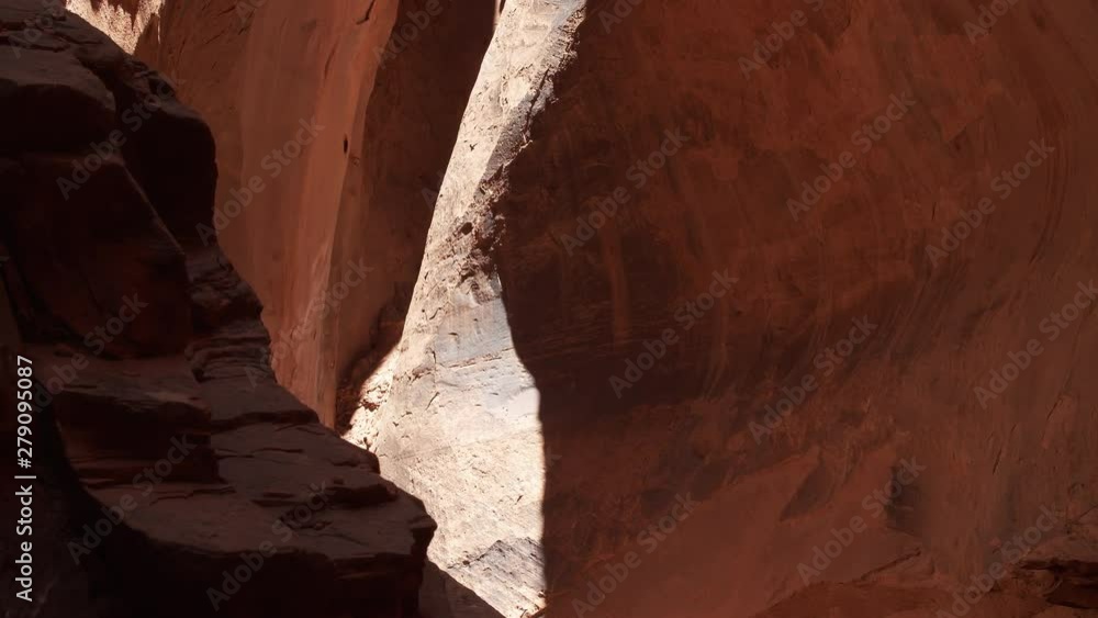 Slow motion tracking shot to the left in the Long Canyon Slot in the Grand Staircase Escalante National Monument. Water can be seen reflecting on the back wall. Slow motion tracking shot to the left in the Long Canyon Slot in the Grand Staircase Escalante National Monument. Water can be seen reflecting on the back wall.