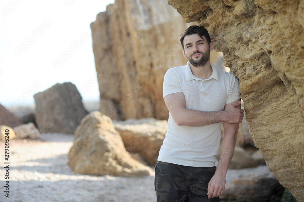 Handsome man outdoor portrait near rocks Handsome man outdoor portrait near rocks