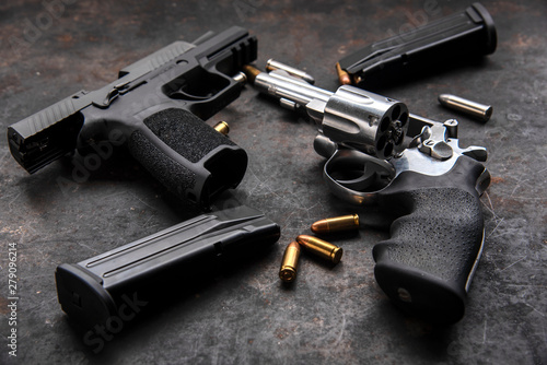 Gun with ammunition on dark background. 