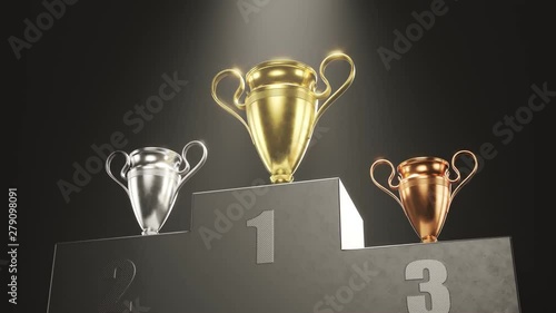 Golden, silver and bronze metallic trophy cups on a podium in the spotlight 4KHD photo