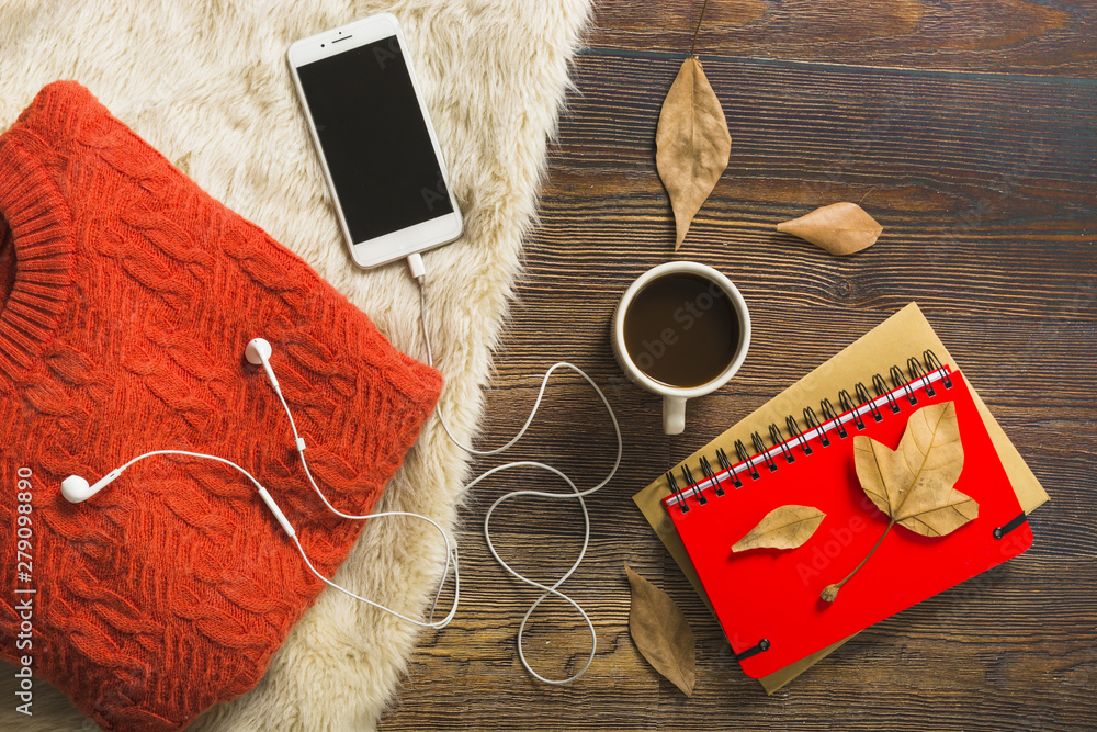 Coffee and smartphone near jumper and notebooks Coffee and smartphone near jumper and notebooks