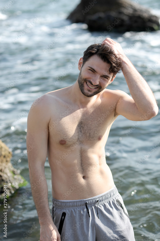 Happy man topless portrait, smiling with teeth braces Happy man topless portrait, smiling with teeth braces