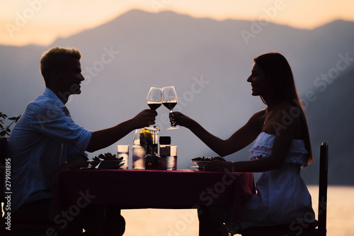 Couple sharing romantic sunset dinner on tropical resort