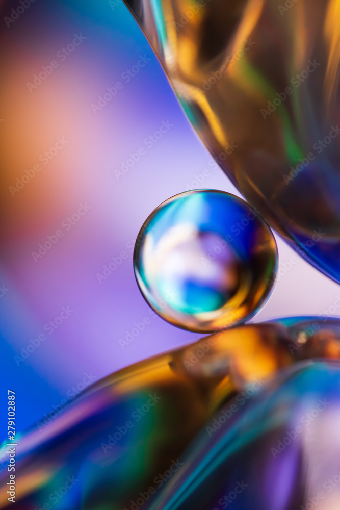 Marble on glass plate in blue background Marble on glass plate in blue background