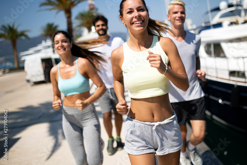 Running  friends  sport  exercising and healthy lifestyle concept. Happy people jogging outdoor.