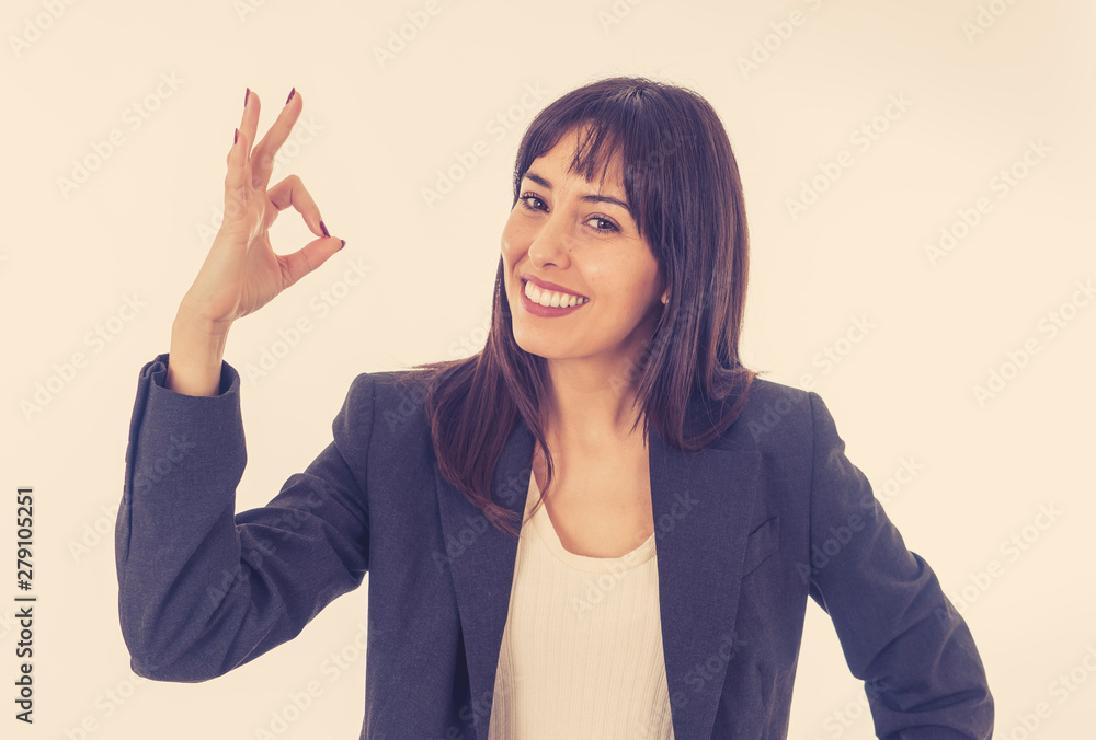 Portrait of a young beautiful smiling business woman doing O.K. sign. Isolated on white background Portrait of a young beautiful smiling business woman doing O.K. sign. Isolated on white background