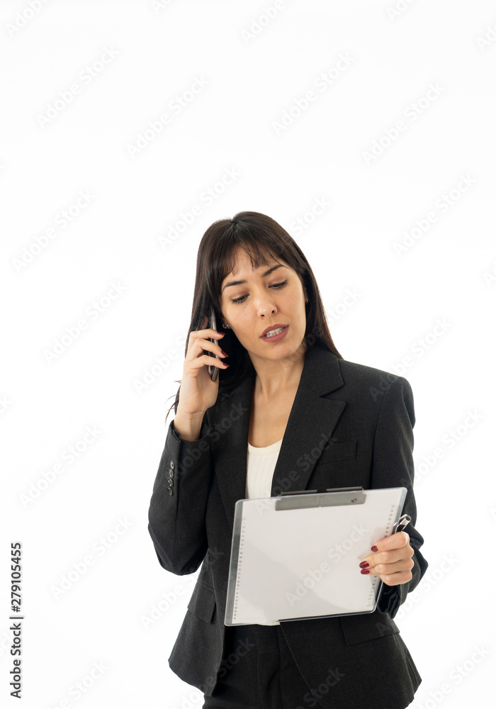 Portrait of a young business woman talking on phone holding a fo Portrait of a young business woman talking on phone holding a fo
