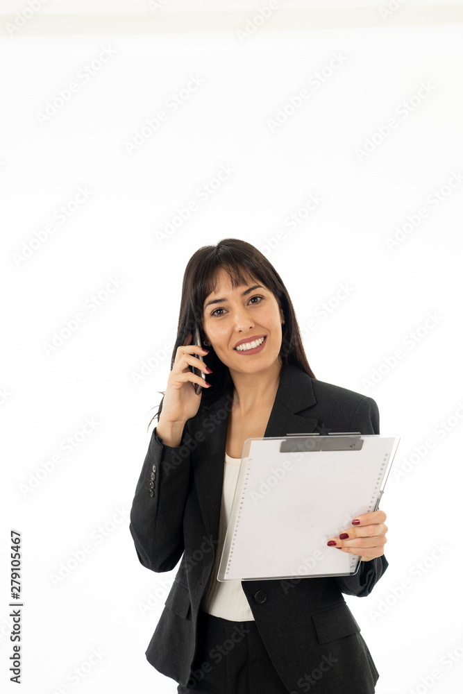 Portrait of a young business woman talking on phone holding a fo Portrait of a young business woman talking on phone holding a fo