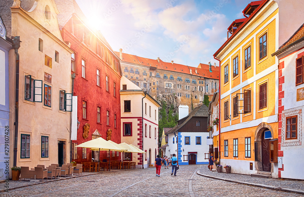Cesky Krumlov, Czech Republic. Ancient street with old houses. Evening sunset with sunlight.