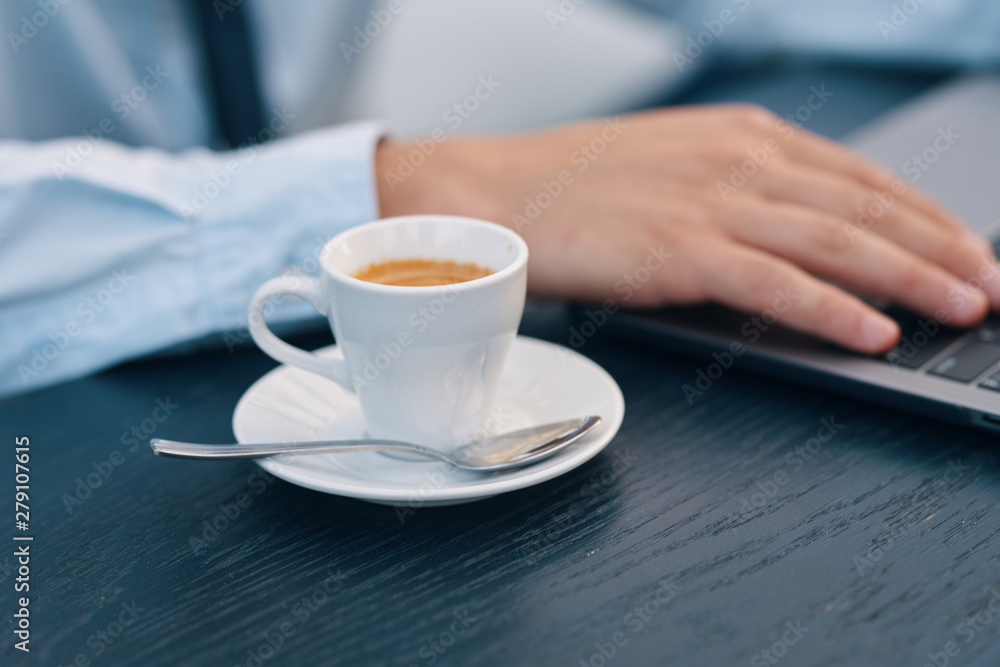 hand holding cup of coffee on table hand holding cup of coffee on table
