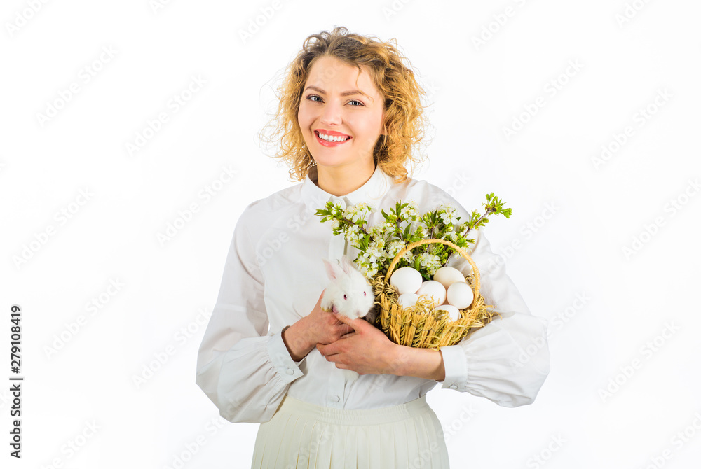 Baby bunny in farmer hands. Organic farming. Friendship with animals. Easter bunny. Small cute rabbit, fluffy white pet. Female farmer holds rabbit. Basket with eggs. Blossoming branch. Local farming. Baby bunny in farmer hands. Organic farming. Friendship with animals. Easter bunny. Small cute rabbit, fluffy white pet. Female farmer holds rabbit. Basket with eggs. Blossoming branch. Local farming.