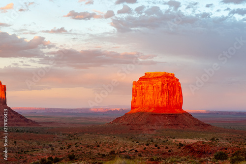 The famous Merrick and Mittens Buttes from monument valley basking in the Light of the setting sun. photo