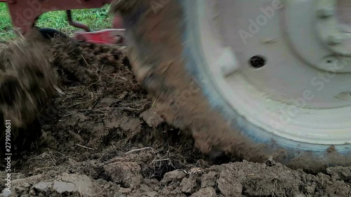 Cultivating Soil with Tractor in the Field