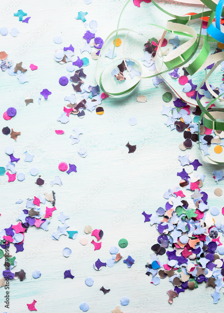 Colorful party festive background with confetti and streamers. Flat lay