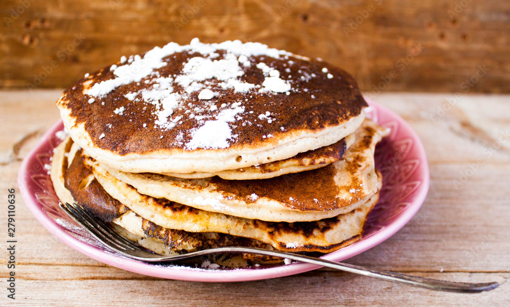 Homemade pancakes on a black cast iron skillet with berries on wooden background vintage tableware Homemade pancakes on a black cast iron skillet with berries on wooden background vintage tableware