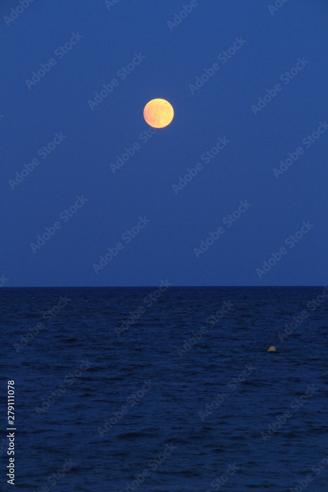 Alicante Beach at dusk with a full moon Alicante Beach at dusk with a full moon