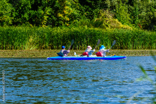 Senior man and two women kayaking on Dnieper river