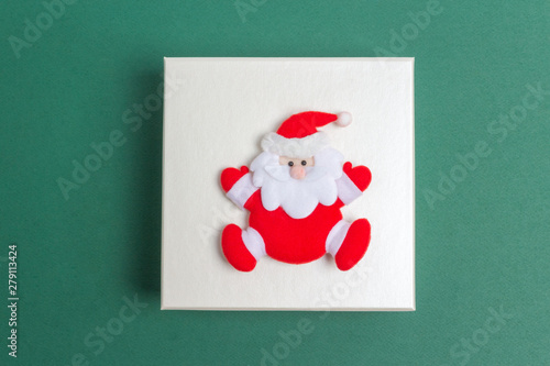 Small Santa Claus on a Christmas Day Gift Box