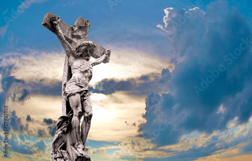 Fotografija marble Holy cross with crucified Jesus Christ against dramatic sunset