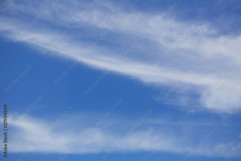Sky with cumulus clouds. The background is blue and white. Bright sunny day. Copy space.