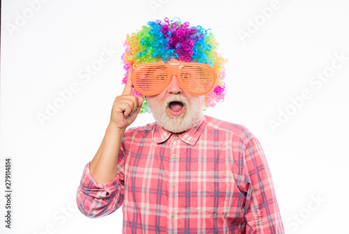 happy birthday. corporate party. anniversary holiday. mature bearded man in colorful wig and party glasses. happy man with beard. Celebration retirement. Crazy man in playful mood. Unusual idea