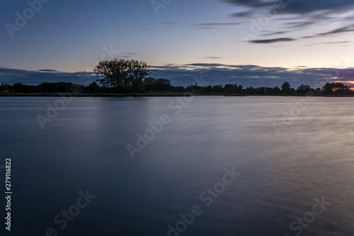 Blurry clouds over the water after sunset, long exposure time © darekb22