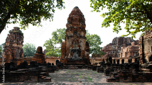 Front view of a Ruined pagoda of the temple ruins of Ayutthaya with trees leaves