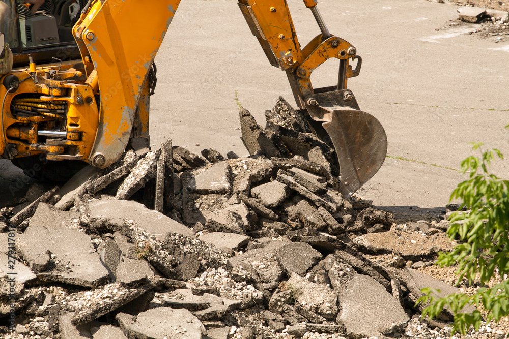 Fototapeta premium Tractor Dismantles Asphalt